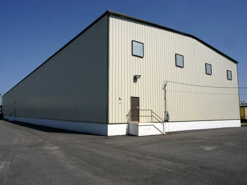 White cool roof coating applied to a building rooftop demonstrating solar reflectance for energy efficiency in hot climates like Newton, Alabama